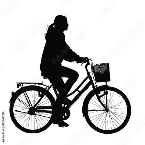 Silhouette of a woman riding a bicycle with a basket in front