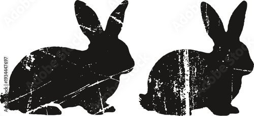 silhouettes of two rustic vintage rabbits facing opposite directions with textured distressed