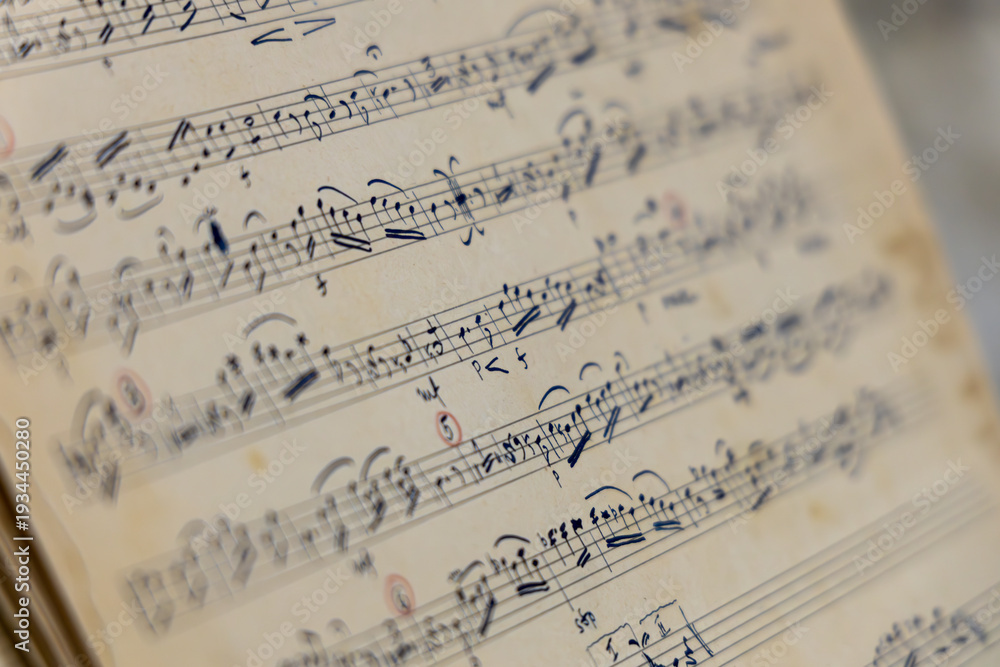 Fototapeta premium Close Up of Vintage Handwritten Sheet Music with Musical Notes on Aged Paper, Classical Composition Manuscript Background, Artistic Inspiration and Music Education Concept