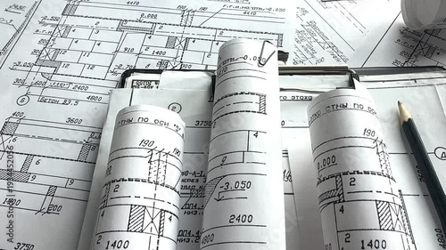 Architecture blueprints with rolled plans, compass and clipboard on desk, construction documentation and engineering design workflow, BIM planning and project management concept, copy space.