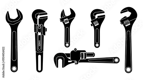 Various wrenches and spanners arranged neatly on a plain background