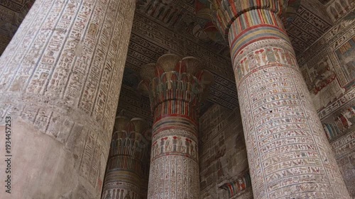 Egypt. Esna temple hypostyle hall with massive painted columns and colorful hieroglyphic reliefs on ceiling in Egypt, ancient Roman-era architecture with preserved pigments and carvings.