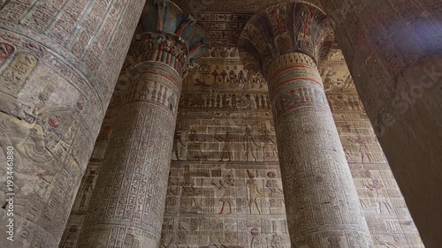 Egypt. Esna temple hypostyle hall with massive painted columns and colorful hieroglyphic reliefs on ceiling in Egypt, ancient Roman-era architecture with preserved pigments and carvings.