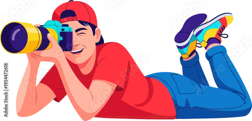 Enthusiastic photographer lying down with professional camera and lens