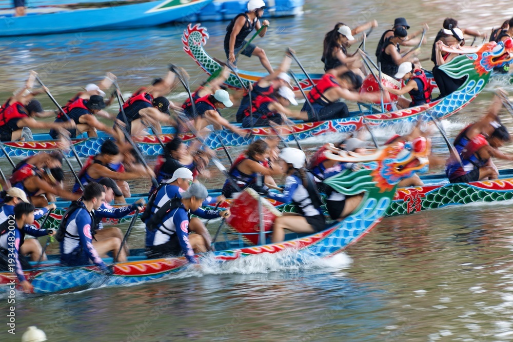 Fototapeta premium Scene of a competitive boat racing in the Dragon Boat Festival in Taipei, Taiwan, where the athletes pull vigorously on the oars compete with all their strength in traditional colorful dragon boats