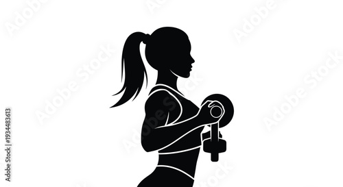 Silhouette of a woman lifting a dumbbell during a workout session