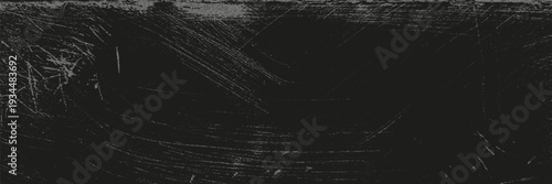 Rough old black scratched surface with a grunge texture used as a backdrop or background for various projects.