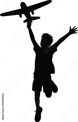 Black silhouette of a joyful young boy jumping while holding a toy airplane for childhood imagination dreams of flight travel and active play concepts.