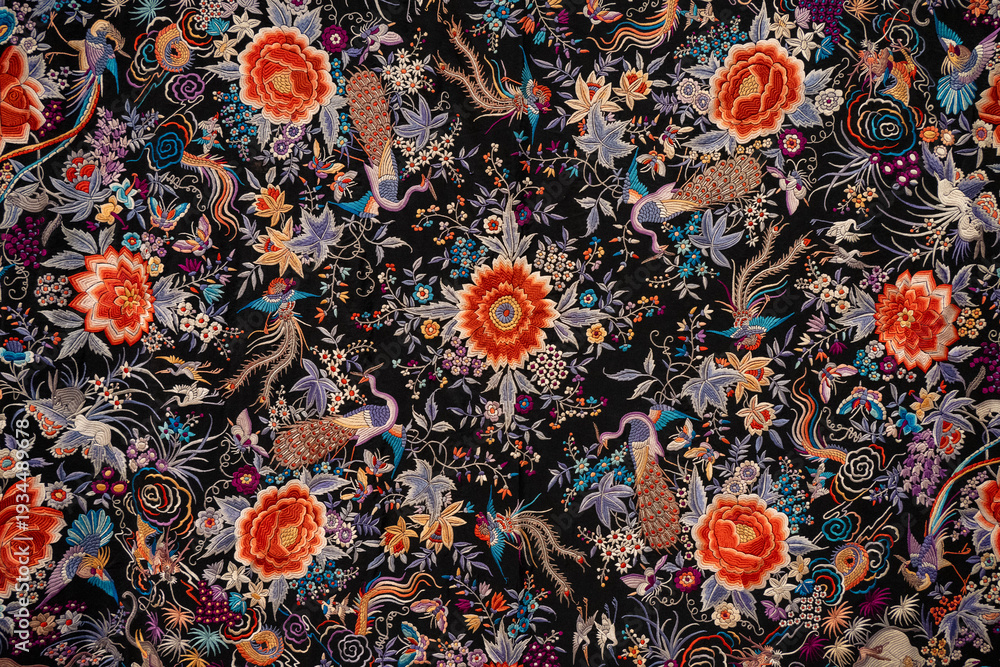 Obraz premium Sevilla, Spain - 23 Dec 23: Colorful floral embroidery pattern on black textile, Seville museum