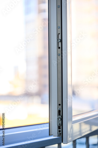 Close-up view of modern window frame with sliding mechanism and city background Free Download Close-up view of modern window frame with sliding mechanism and city background - GFXLoad