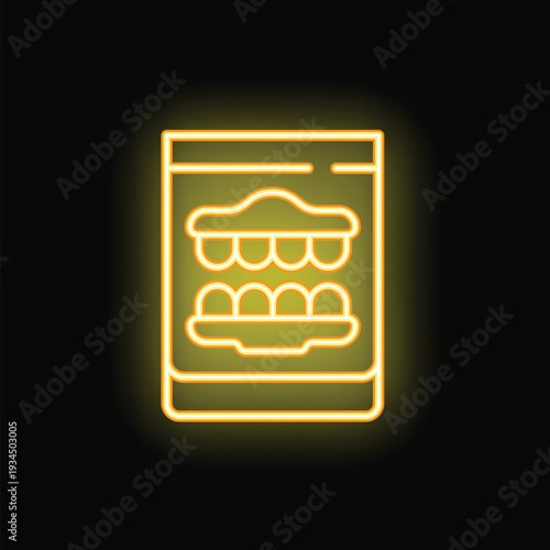 Yellow glowing neon sign representing a dental prosthesis on a black background