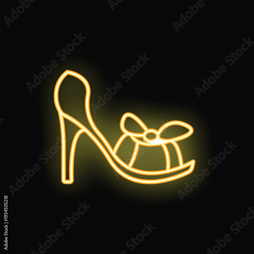 Yellow neon sign representing a high heel shoe with bow on black background