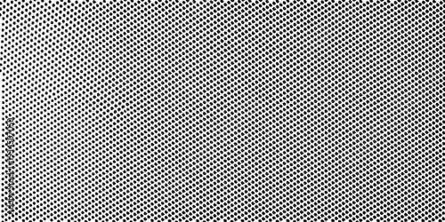 A dense repeating pattern of small black circles on a white background