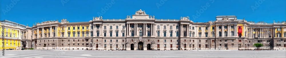 Obraz premium Grand royal palace with classical imperial architecture under a clear blue sky for European tourism and travel advertising, wide street level panorama exterior view