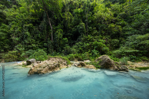 Photos calm turquoise creek with boulders in the tropical lush jungle, Badian, Cebu, th