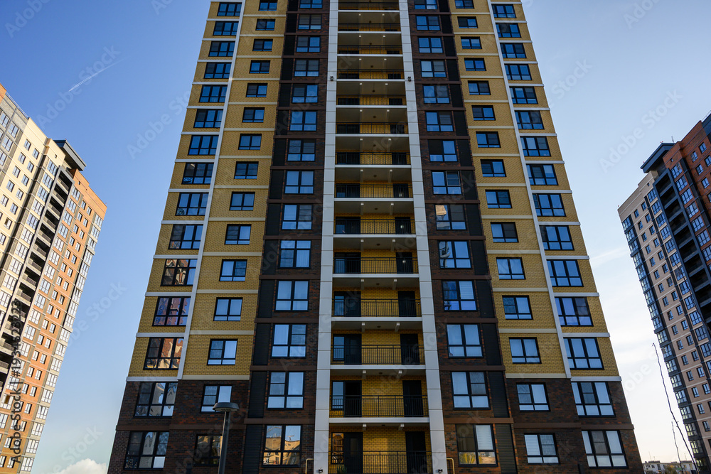 Fototapeta premium Modern residential apartment building with colorful facade and balconies