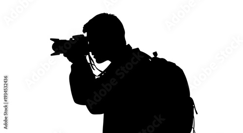 Man holding camera to face side.