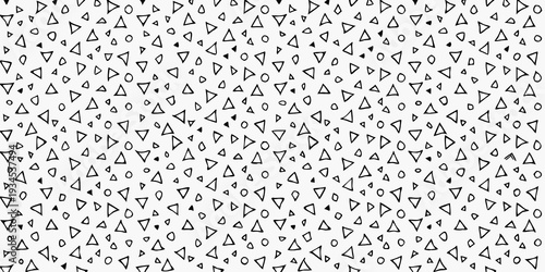 Dense pattern of randomly oriented black triangles on a white background