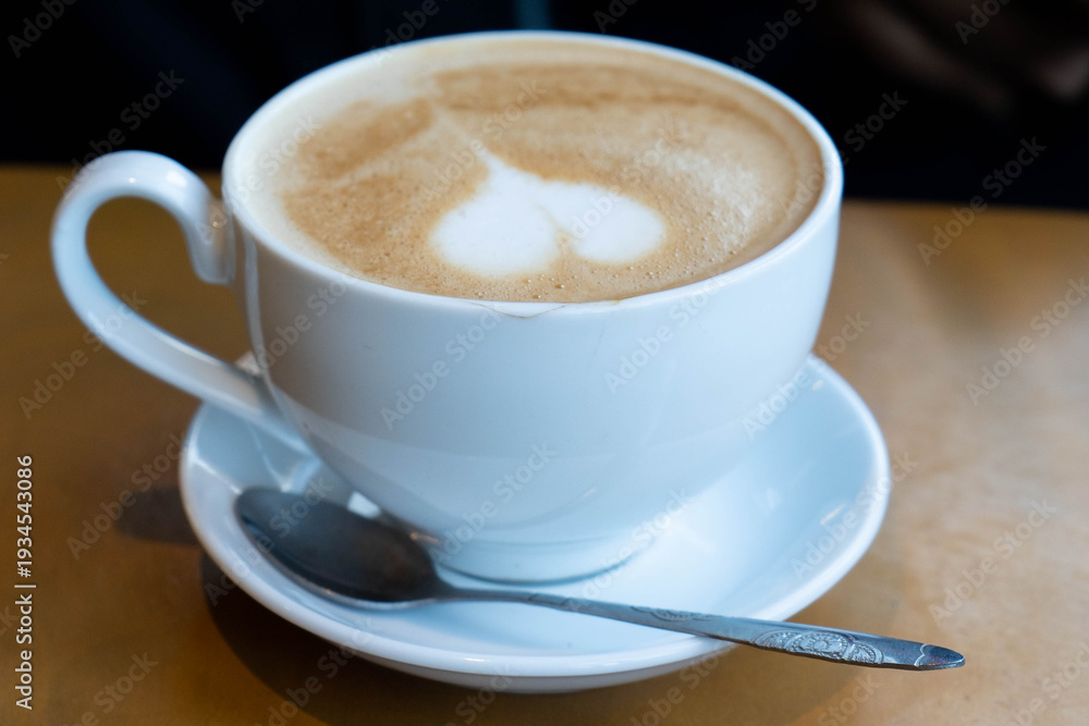 Fototapeta premium Hot latte with heart shaped foam art in cafe in Da Lat, Vietnam