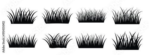black silhouette reveals nine clumps of grass in varying