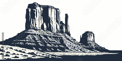 Majestic rock formations rise dramatically from the desert landscape under a clear sky