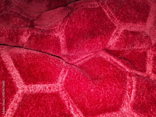 Close up view of red fabric with a distinct geometric texture
