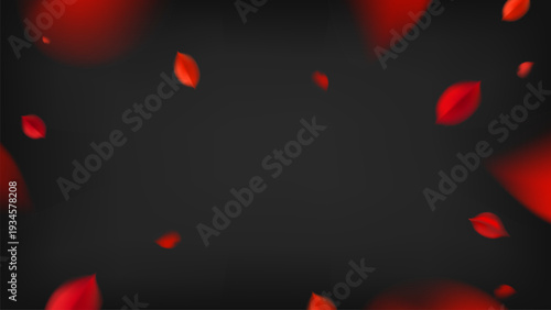 Red falling leaves on a dark background, evoking autumn's beauty.