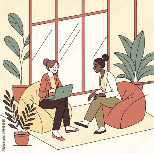 man and woman in the office. Two businesswomen discussing work using a laptop in a modern office 