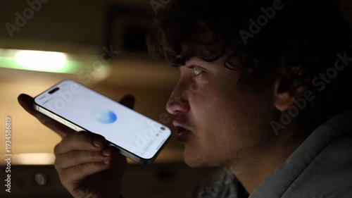 Student in dark room at night using smartphone talking with chatgpt asking academic questions ai assistant helping with homework and study tasks