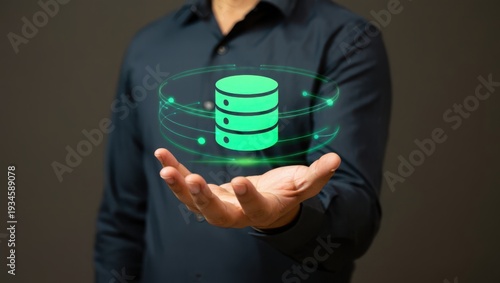 Man in blue shirt holding green database icon with glowing lines around it in his hand