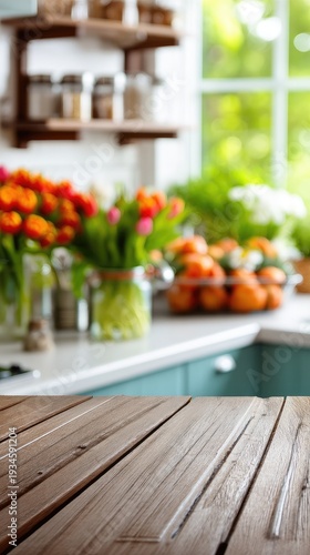 Wooden table top shows a spring kitchen with blurred background and flowers on the window sill for display ideas