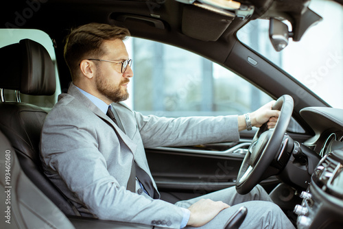 Businessman driving a car i...