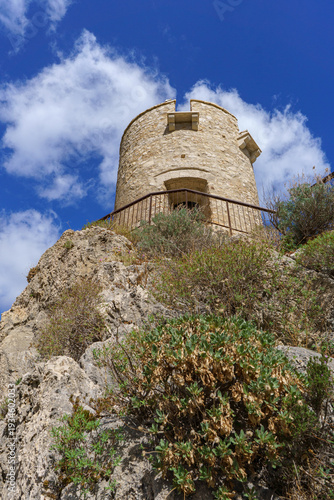 Dramatic Low-Angle View of the Ancient Stone Torre Bennistra Watchtower on its Rocky Summit, Scopello, Sicily