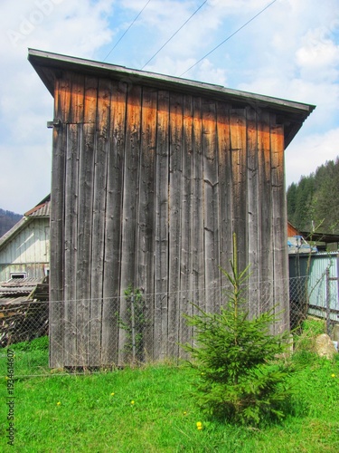 Tall weathered wooden barn with aged blackened timber planks