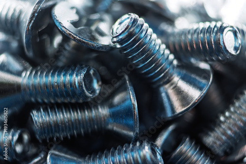 Macro shot of bright galvanized DIN 965 screws, showcasing precise threads and a lustrous metallic finish. Essential hardware texture