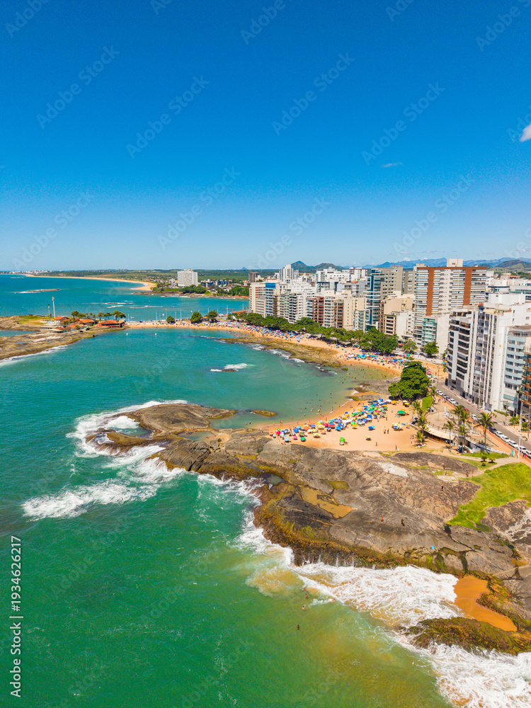 Fototapeta premium Aerial view of crowded beaches in downtown Guarapari during summer tourism season, Brazil