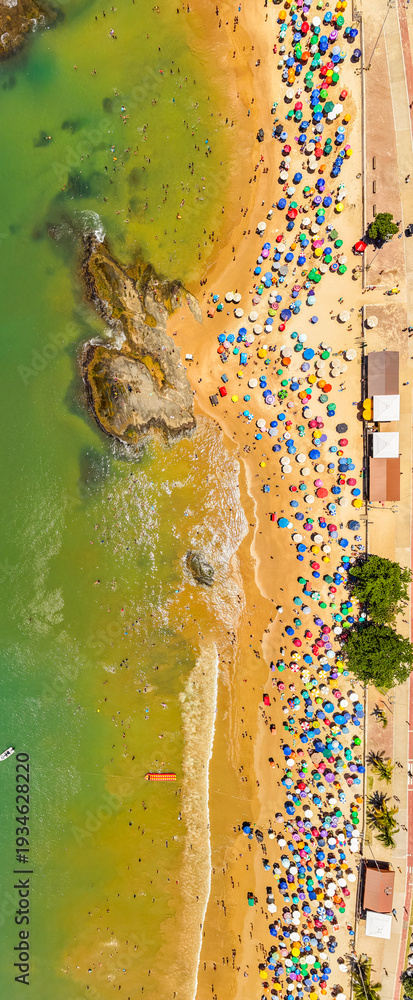 Obraz premium Aerial view of crowded Praia do Morro beach during summer tourism season in Guarapari Brazil
