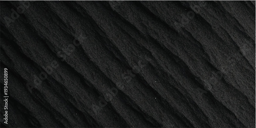 Detailed black rubber mat texture featuring patterns similar to vehicle tire designs, suitable for use in industrial, automotive, or abstract design projects