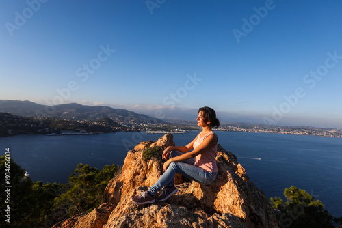 woman sitting on a rock