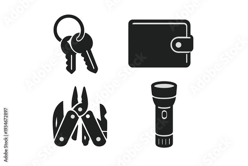 Keys wallet multi-tool and flashlight arranged on a flat surface in a