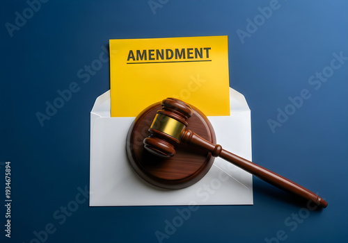 Gavel and amendment document in an envelope on a blue surface