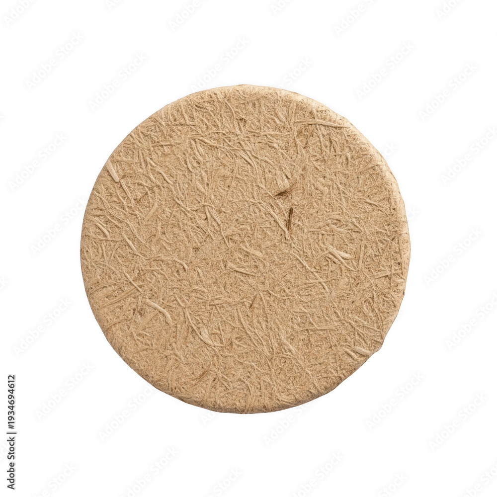 Fototapeta premium A round cork coaster with a textured surface on a white background