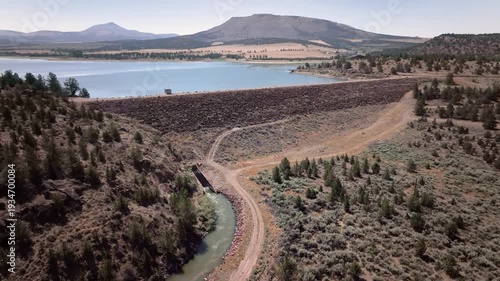 Aerial drone footage over a nearly full reservoir in an arid western landscape.