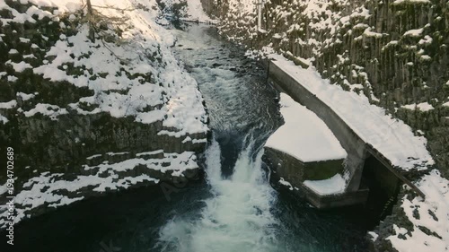Aerial drone clip over and evergreen forest and river in the American West.