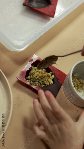 Adding pistachio filling into chocolate mold