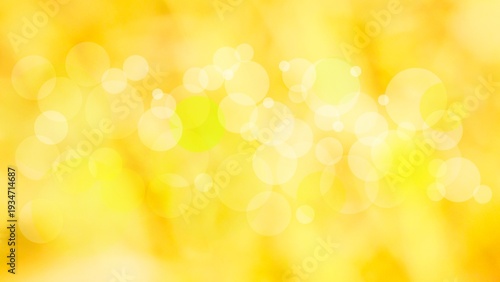 Soft golden yellow bokeh background with blurred light circles and copy space