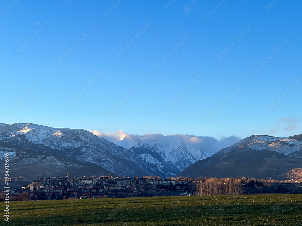 Obraz premium Puigcerda town with Pyrenees mountains and blue sky