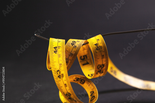 Photos measuring tape isolated on black background with copyspace
