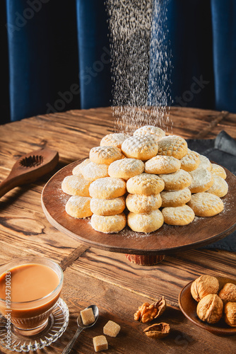 Cookies for celebration of El Fitr Islamic Feast( The Feast that comes after Ramadan).Sprinkling powdered sugar on Kahk (Eid Al- Fitr cookies).