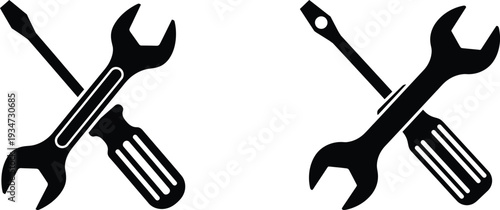 Black and white illustration of crossed wrenches and screwdrivers 